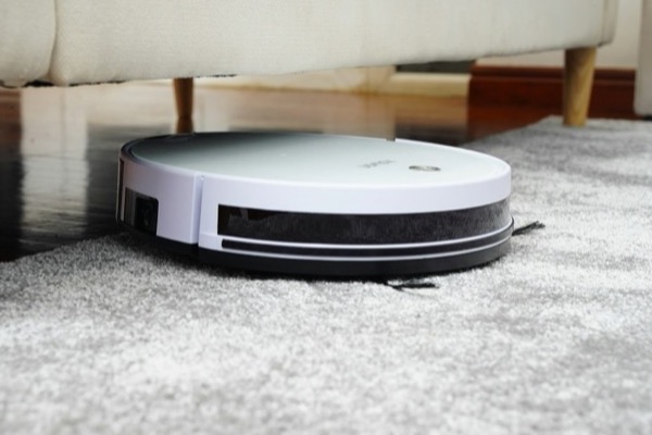 A robot vacuum cleaner on a rug