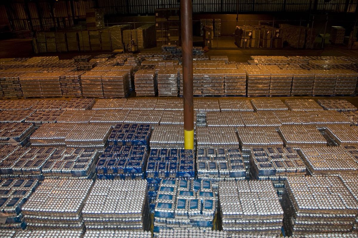 A warehouse floor filled with shrink-wrapped pallets of bottled goods