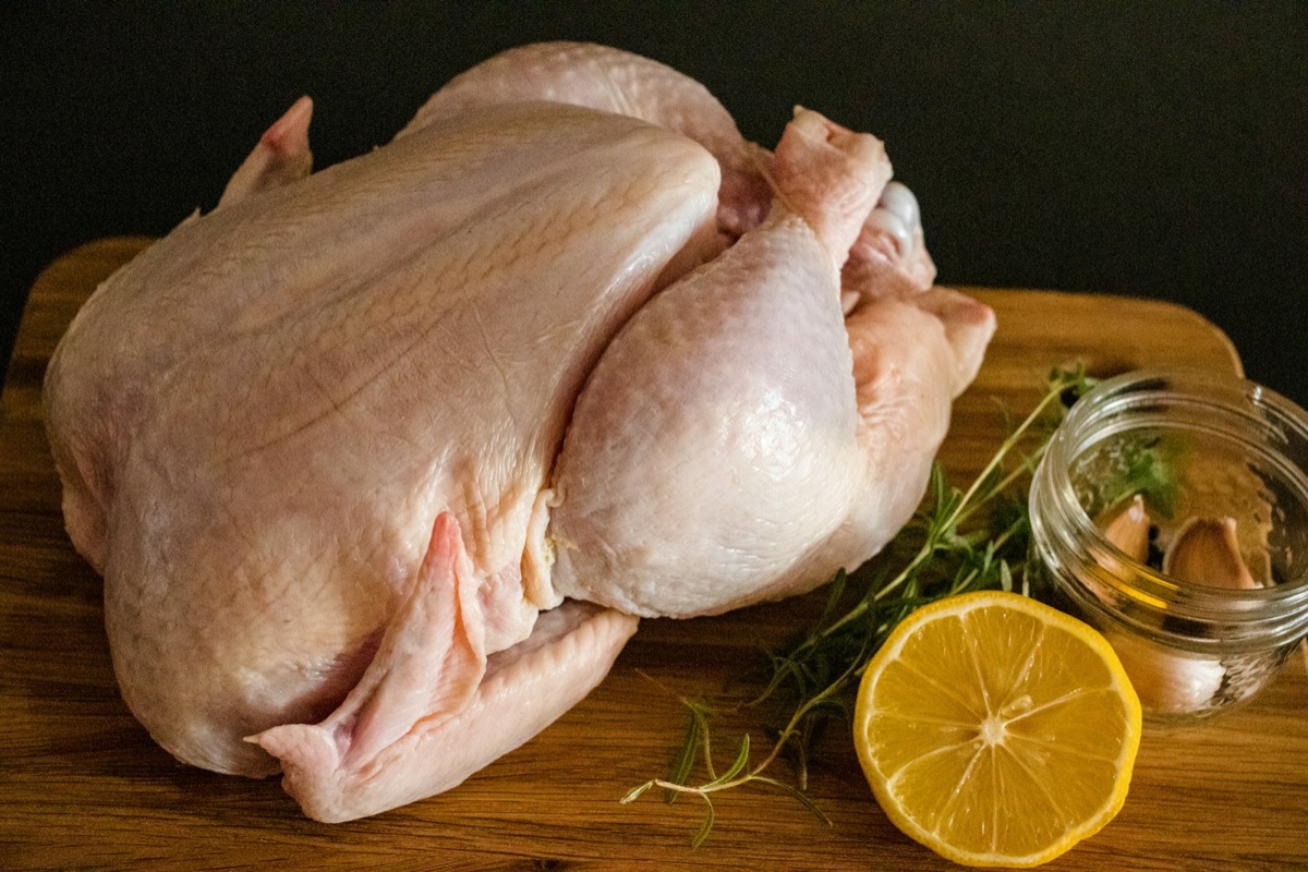 Raw chicken pieces on a chopping board