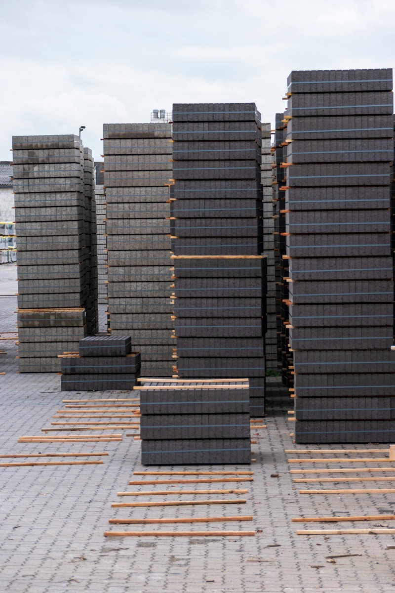Concrete blocks stacked on pallets in a yard